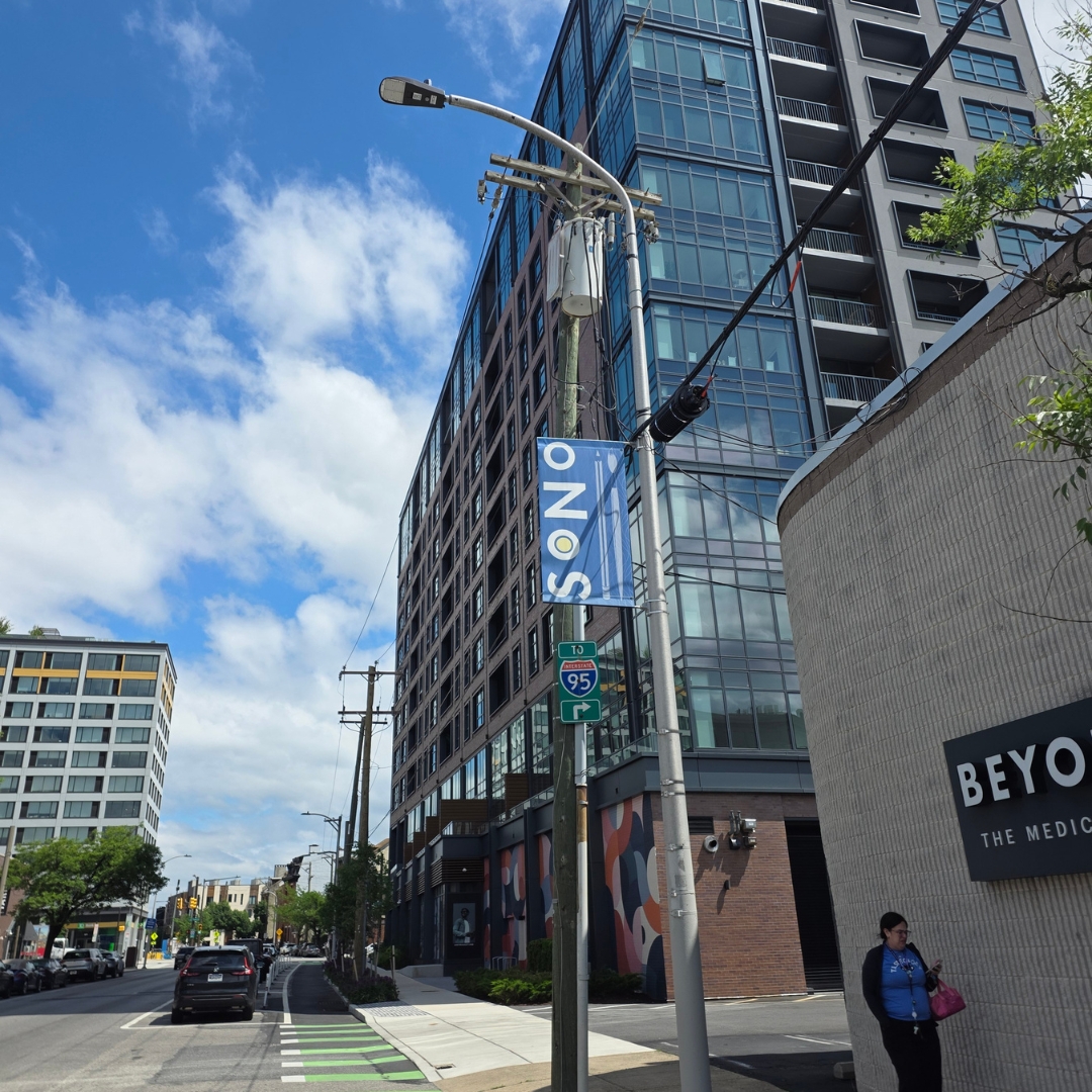 Vertical street pole banner installed on a Philadelphia avenue